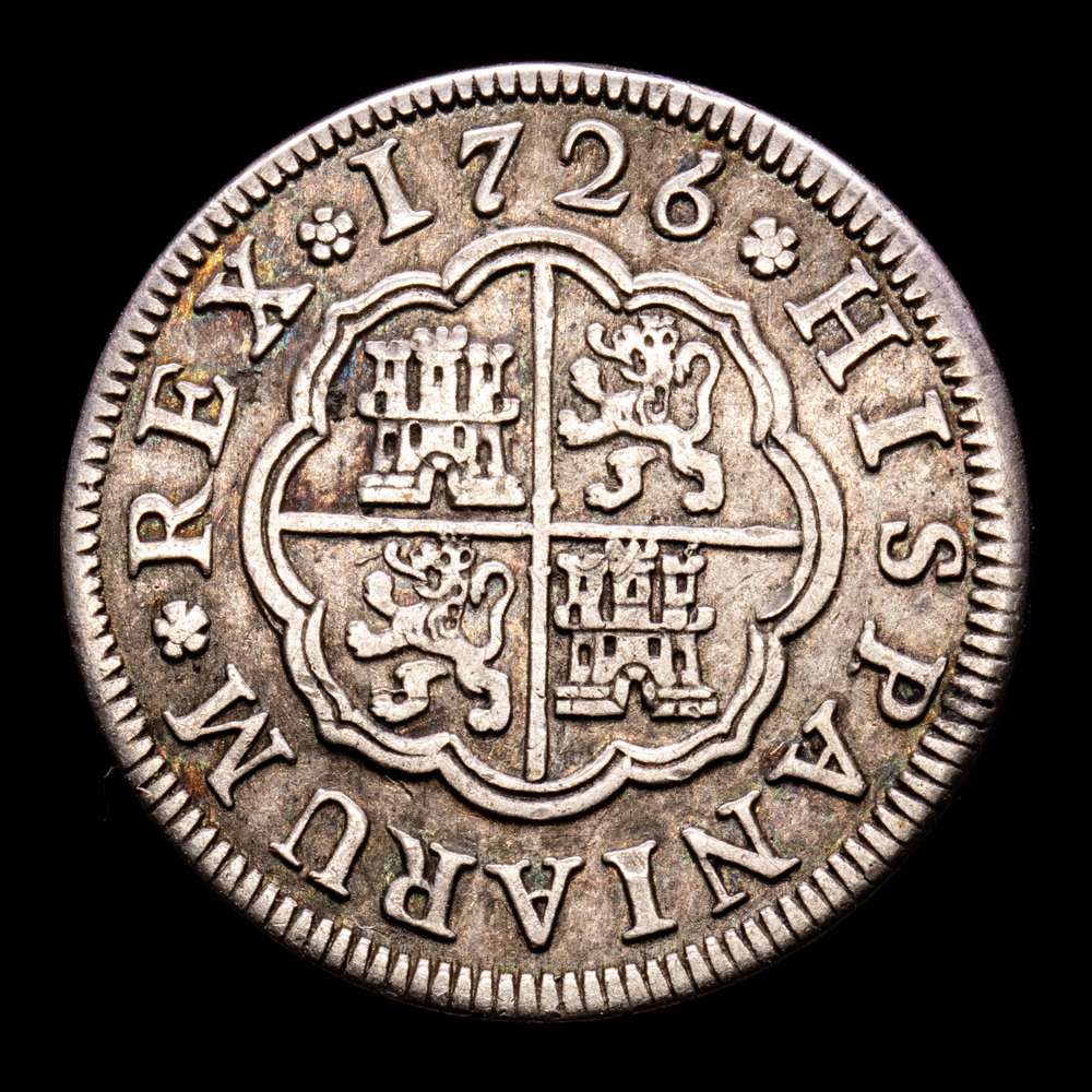 Felipe V. 1 Real. (2,96 g.). Segovia. 1726. Ensayador F. Aureo y Calicó – 241. MBC+. Pátina. Pequeñas hojitas en la gráfila del anverso.