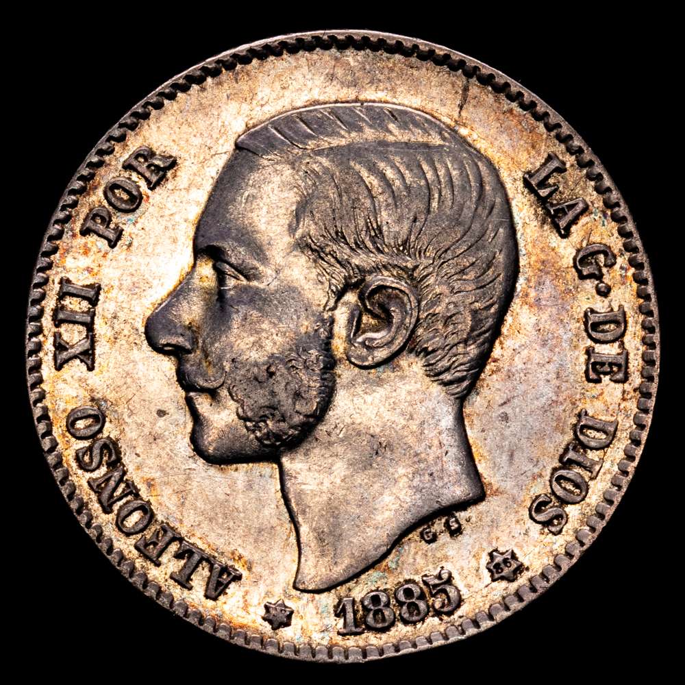 Alfonso XII (1874-1885). 1 peseta. 1885*18-86*. Madrid. MS-M. (Cal-25). Ag.  5,03 gramos. Primera estrella tenue. Parte de brillo original. Muy escasa. MBC+. Suave pátina.